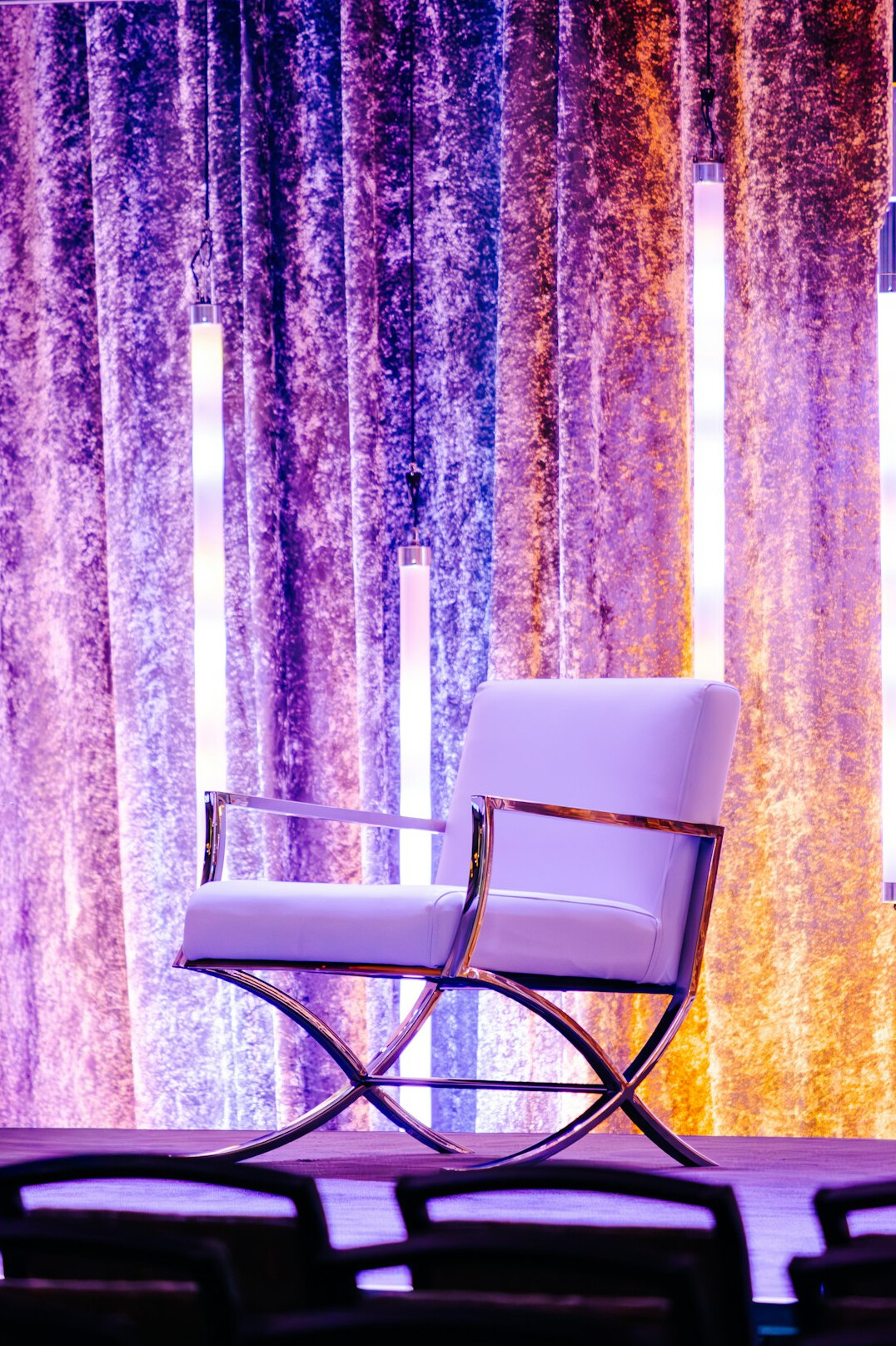 Empty modern conference stage with a podium and warm lighting