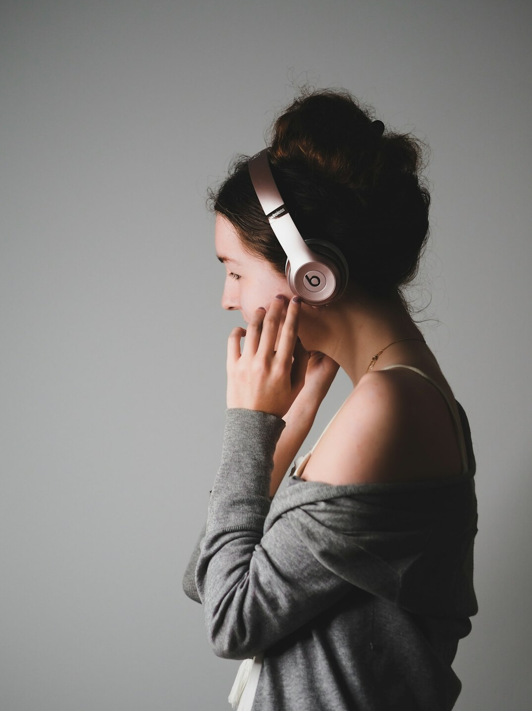 Young woman with a headset practicing voice exercises